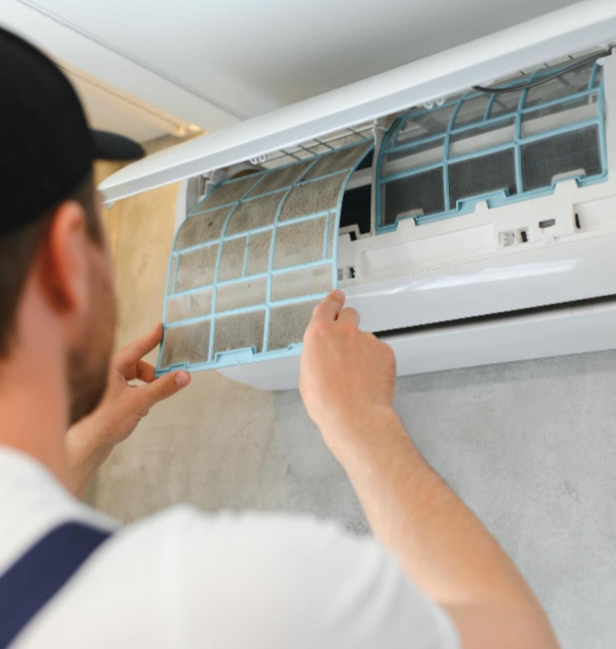 technician checking split type indoor unit